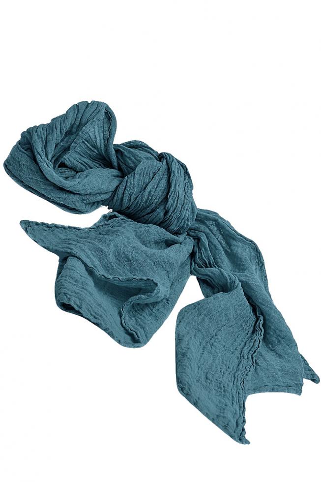 Teal crumpled scarf with a textured, flowy fabric against a white background.