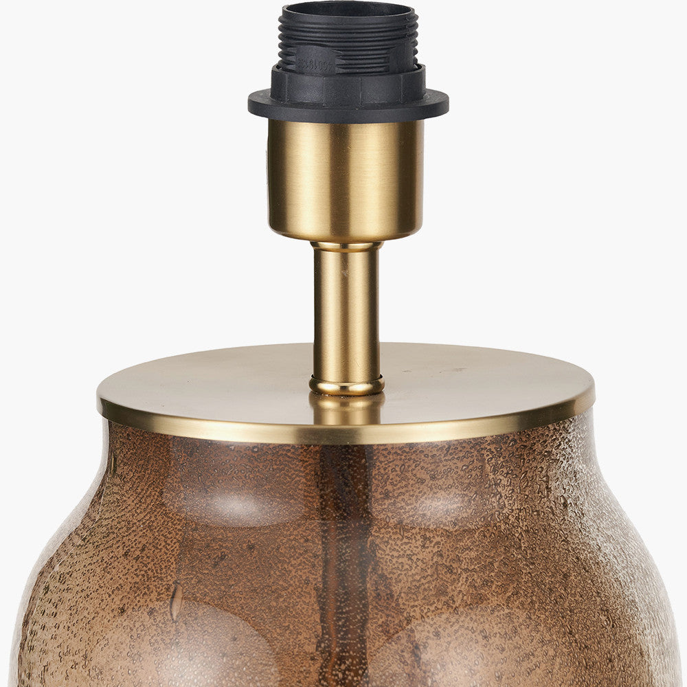 Lamp base with gold and black design on a white background