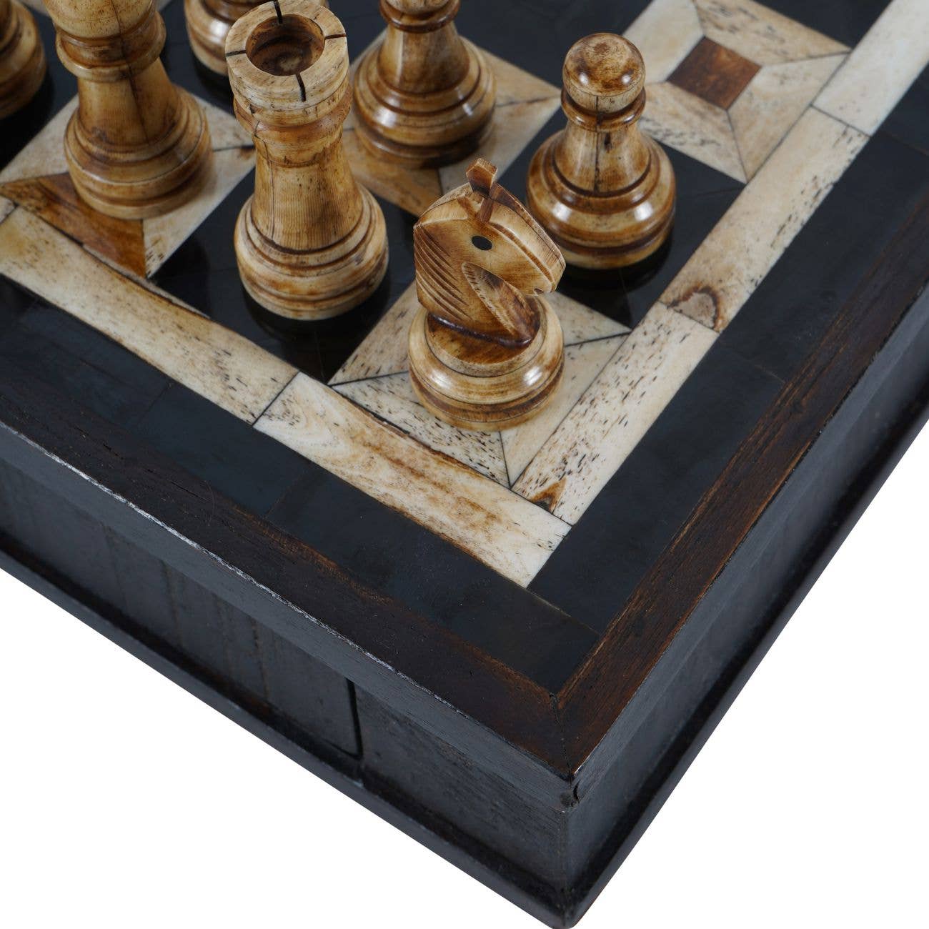 Wooden chess pieces on a decorative chessboard