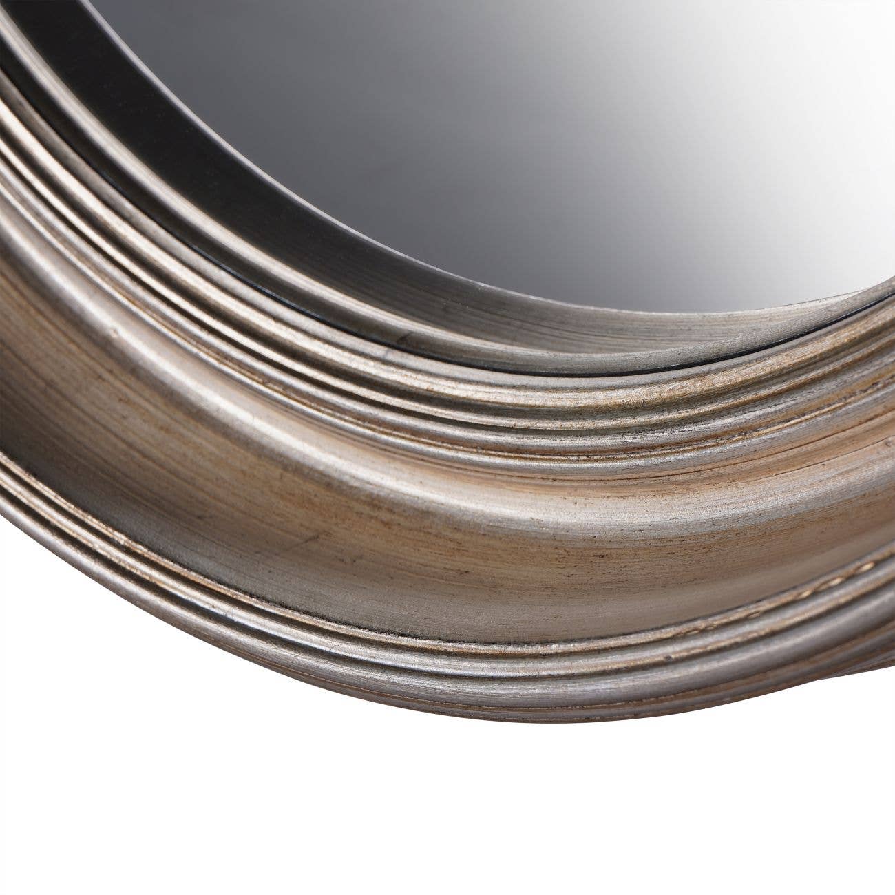 Close-up of a round, ridged silver frame with a reflective glass surface.
