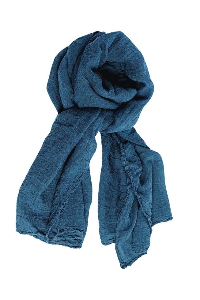 Dark blue, textured scarf with crinkled fabric, loosely looped and draped, against a white background.
