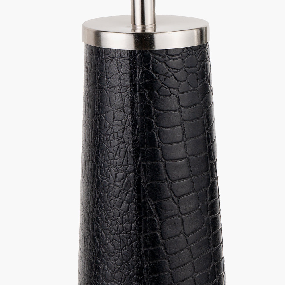 Close-up of black, crocodile-textured lamp base with silver metal top against a white background.