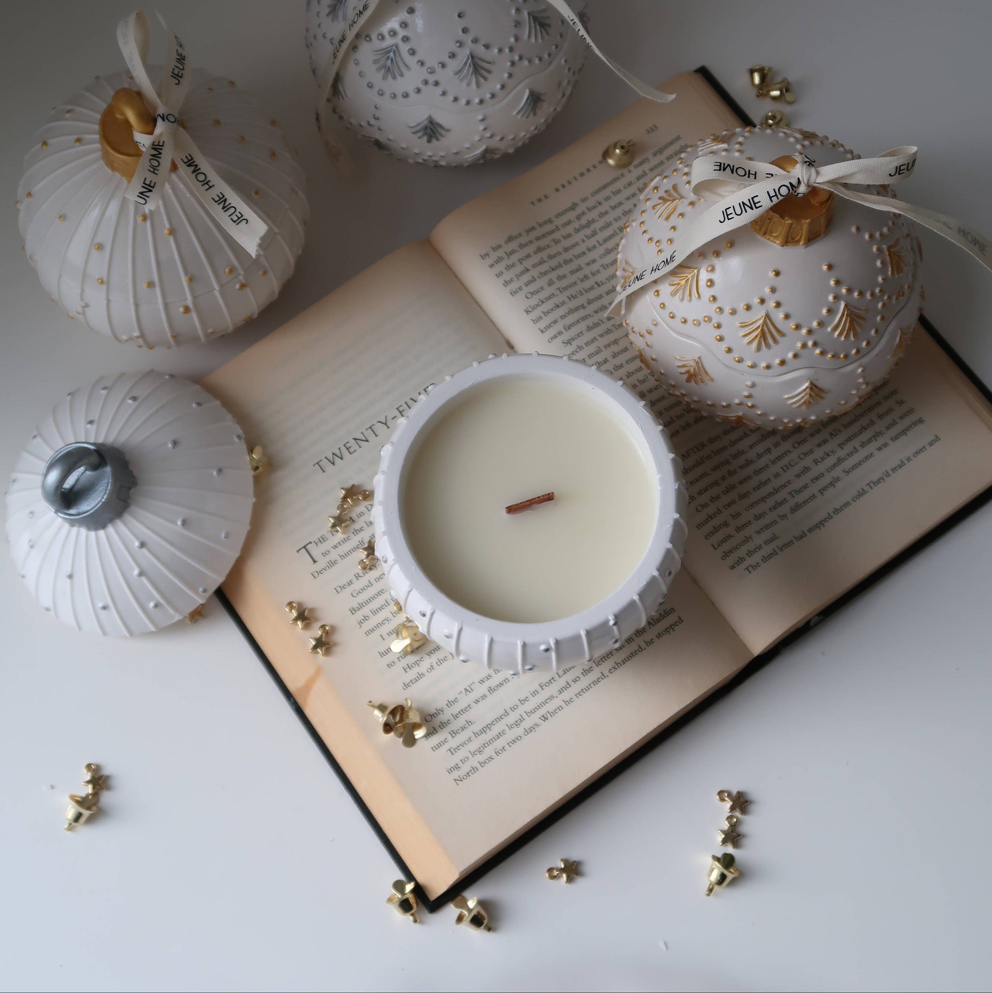 Decorative candles with intricate designs on an open book