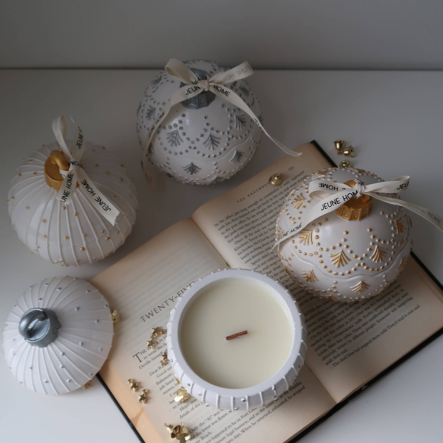 Decorative candles with intricate designs on an open book