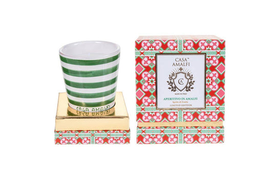 A luxury hand-painted ceramic candle with blue and white stripes, scented with bitter orange and mint, inspired by the Amalfi Coast.