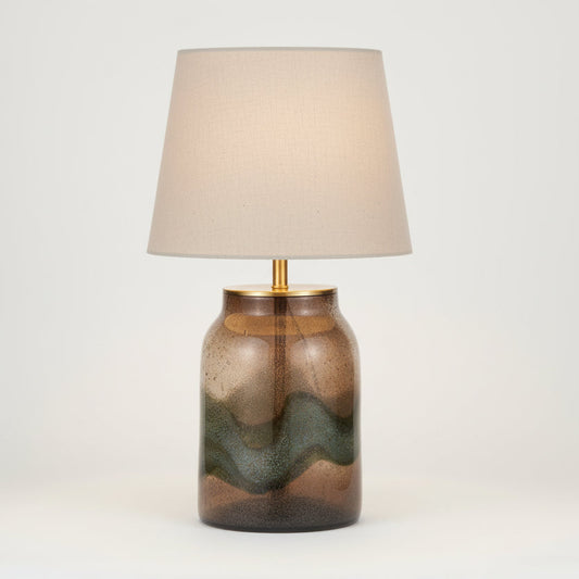 Decorative lamp with a brown and green glass base on a white background