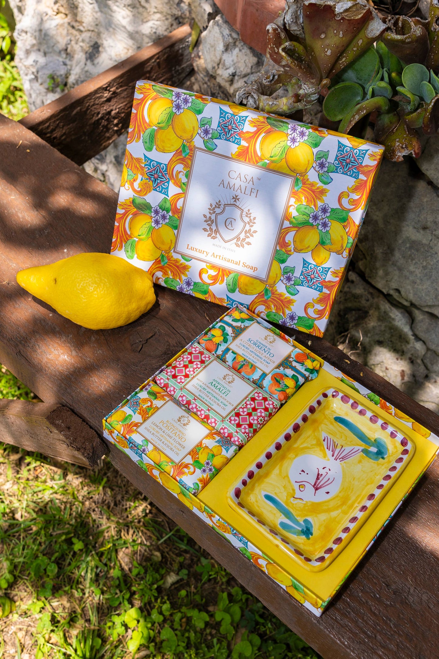 Colorful product packaging with floral and lemon designs on a wooden surface.