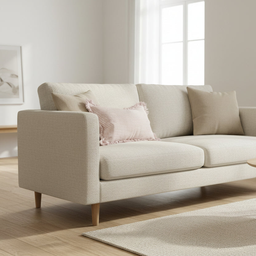 Striped pillow with ruffled edges on a wooden surface against a white wall