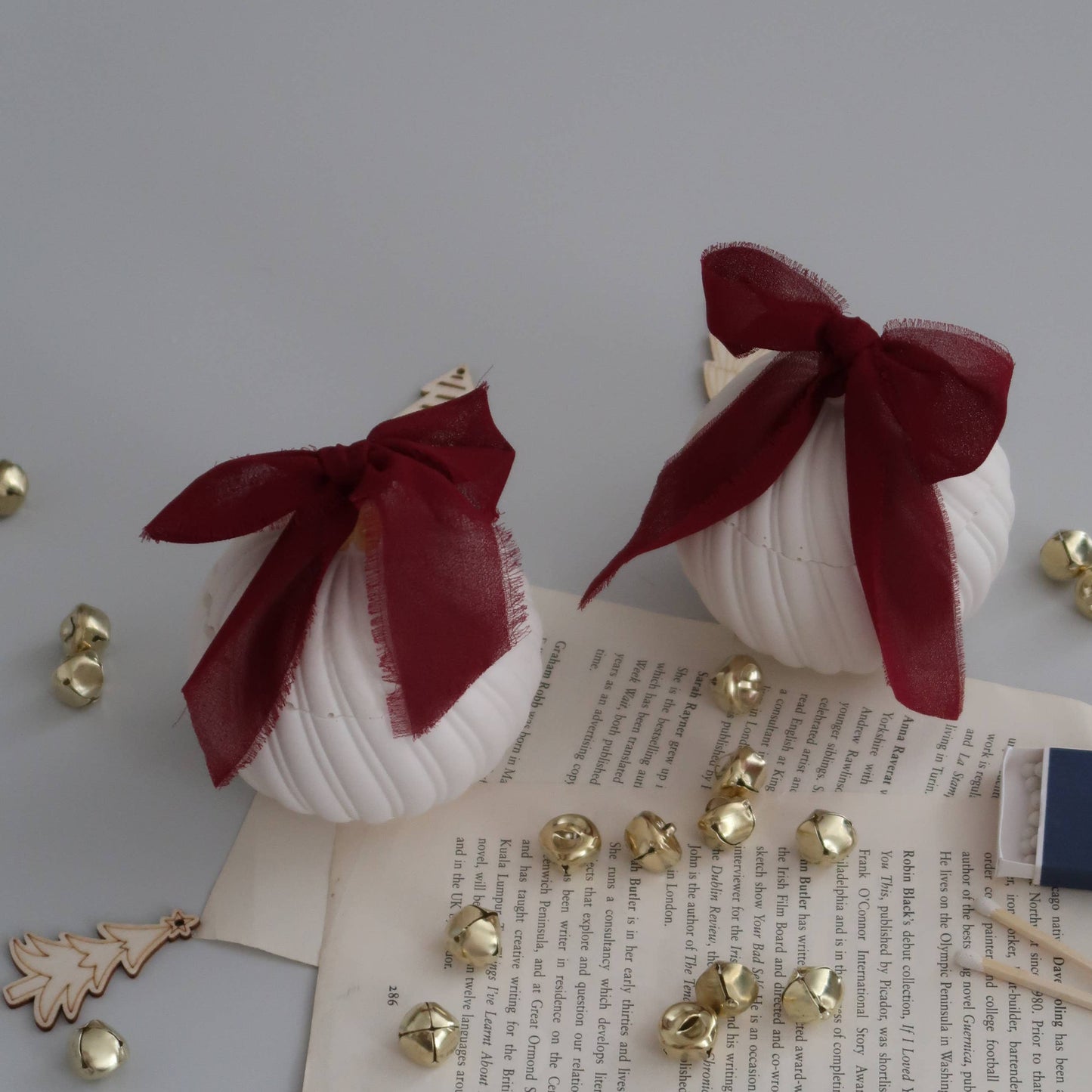 Decorative items with red ribbons and gold accents on a textured surface