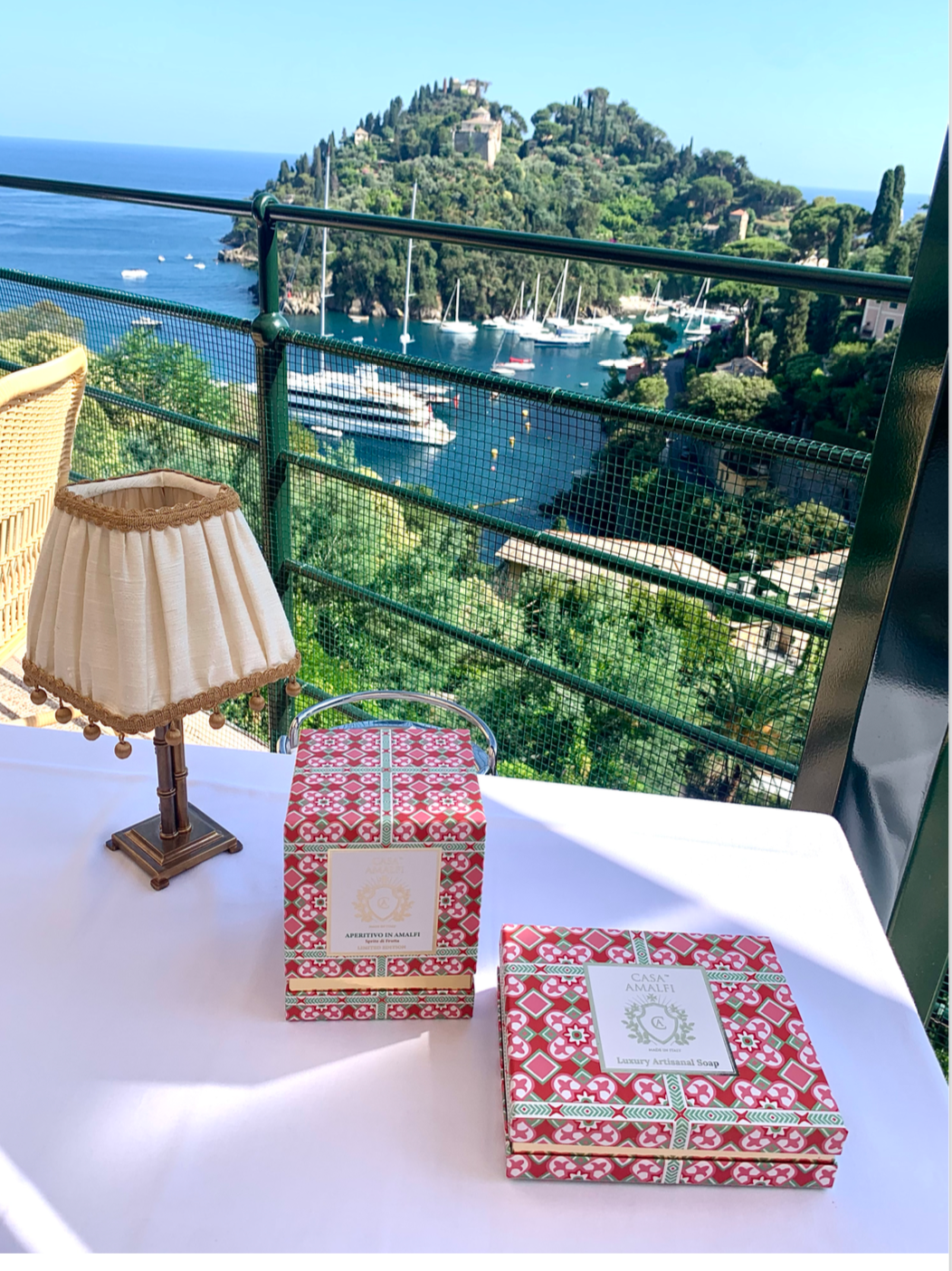 A luxury hand-painted ceramic candle with blue and white stripes, scented with bitter orange and mint, inspired by the Amalfi Coast.