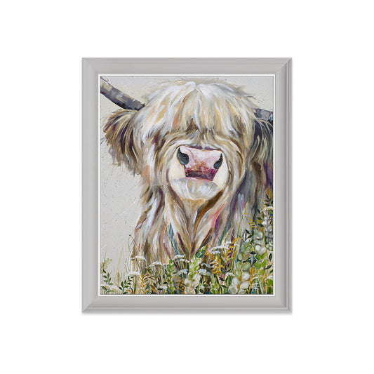 Framed artwork of a highland cow in a field on a white background