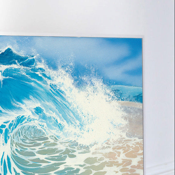Canvas print of a blue wave design on a white wall.