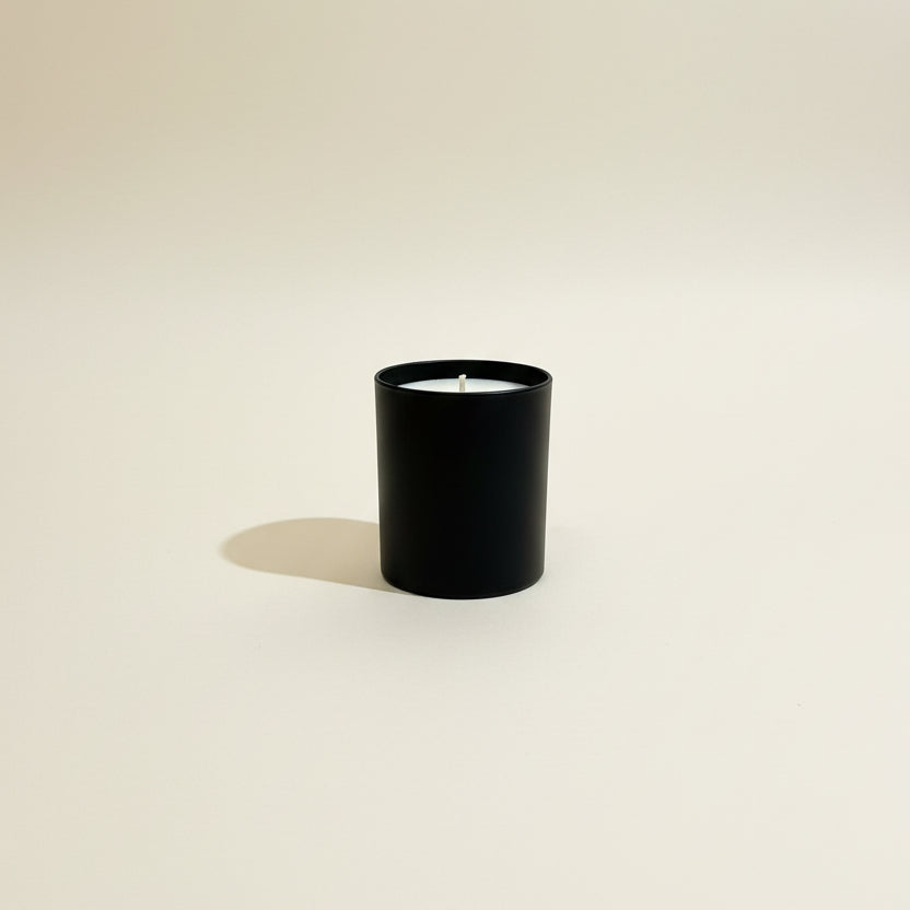 Menes 30cl luxury scented candle in a minimal glass jar, featuring a sophisticated citrus and woody fragrance.