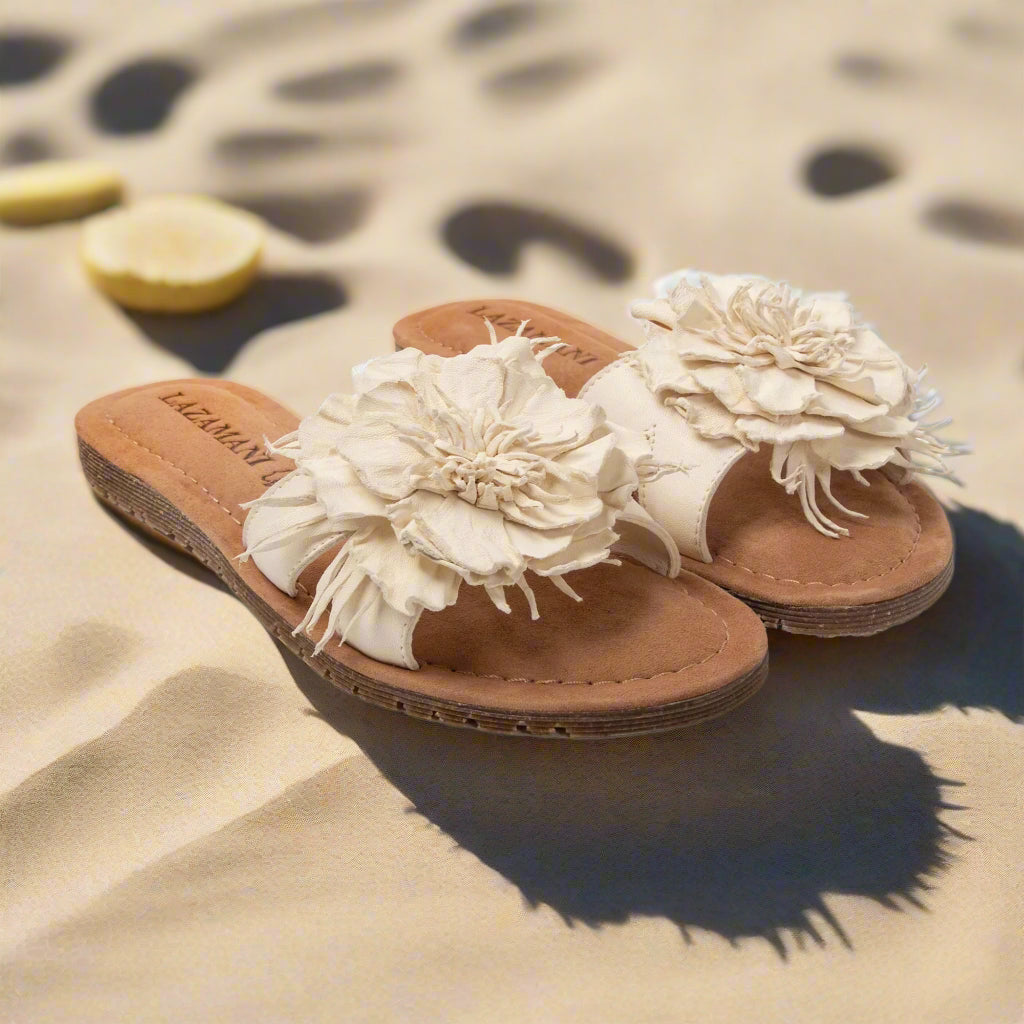 Pair of sandals with floral designs on a light gray background
