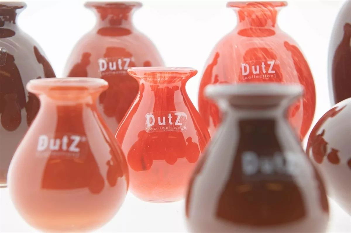 Collection of red and white 'ButZ' containers on a white background