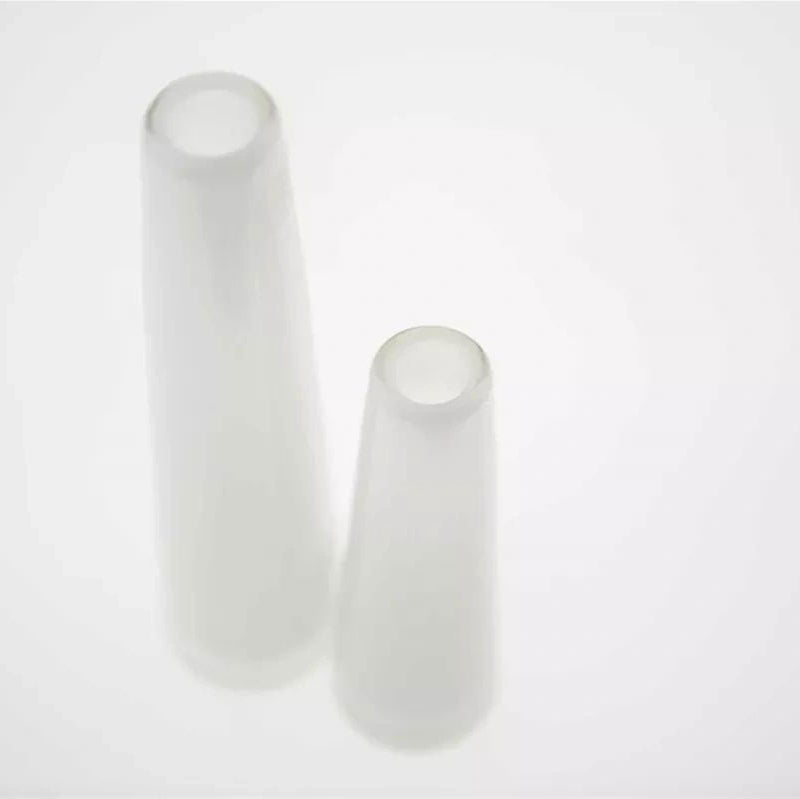 Two white cylindrical objects on a light gray background