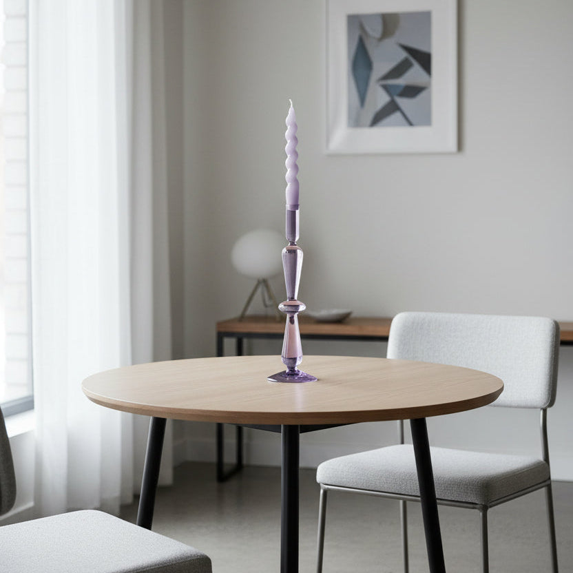 Twisted glass candle on a white background