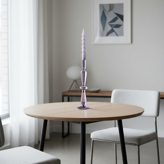 Twisted glass candle on a white background