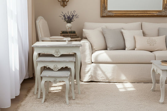 Set of three Nesting tables with decorative carvings on a beige rug.