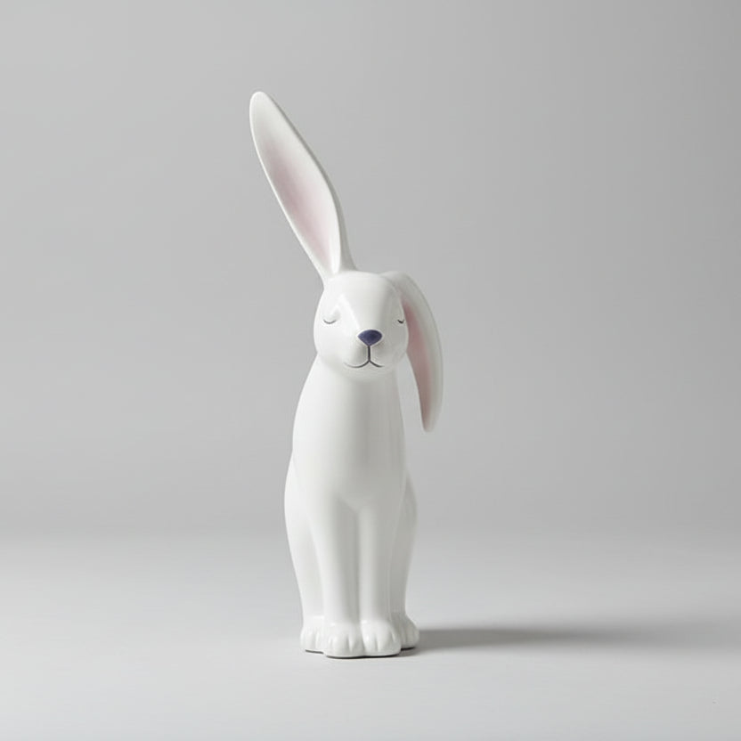 White rabbit-shaped diffuser on a wooden table with a blurred background