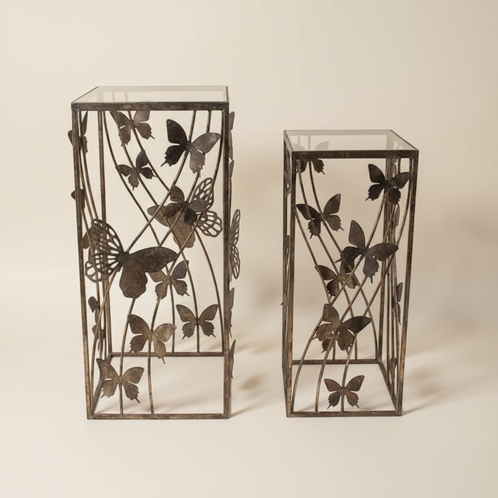 square metal side table with decorative laser-cut butterfly design on the top and sides.