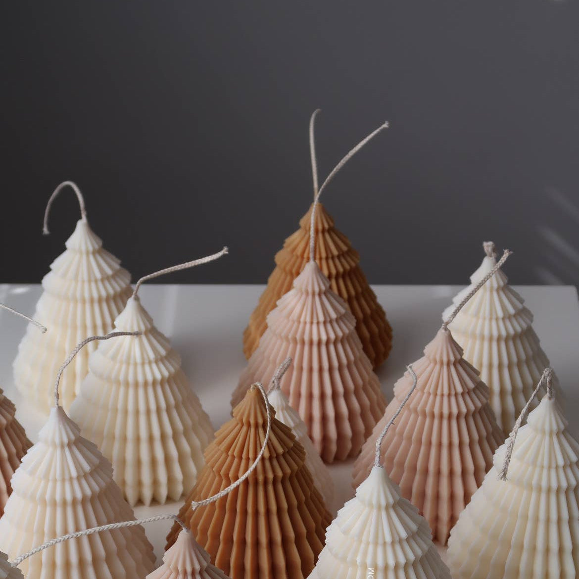 Decorative shell trees on a white surface with a dark background