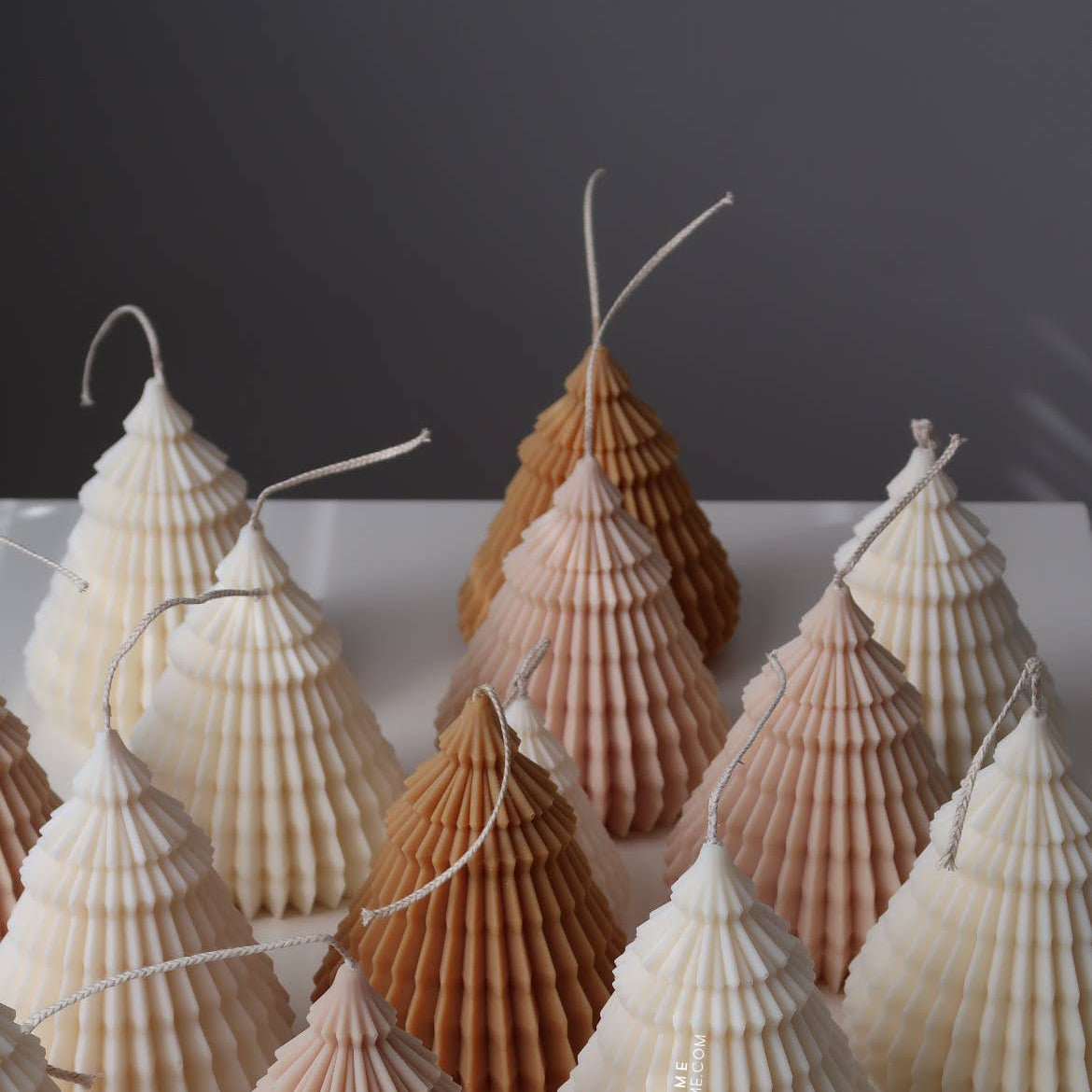 Decorative shell trees on a white surface with a dark background