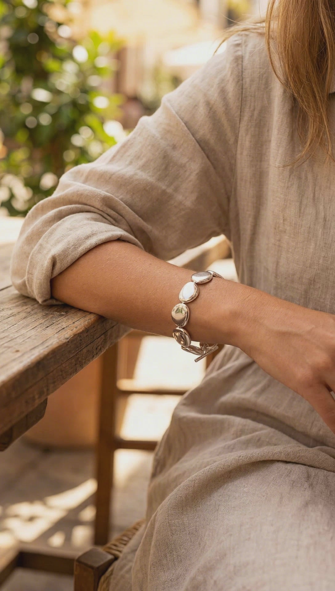 Chunky sterling silver bracelet featuring smooth puffed stone-shaped links and a T-bar toggle clasp on a neutral background.